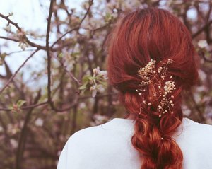 Woman with red velvet hair standing outside 